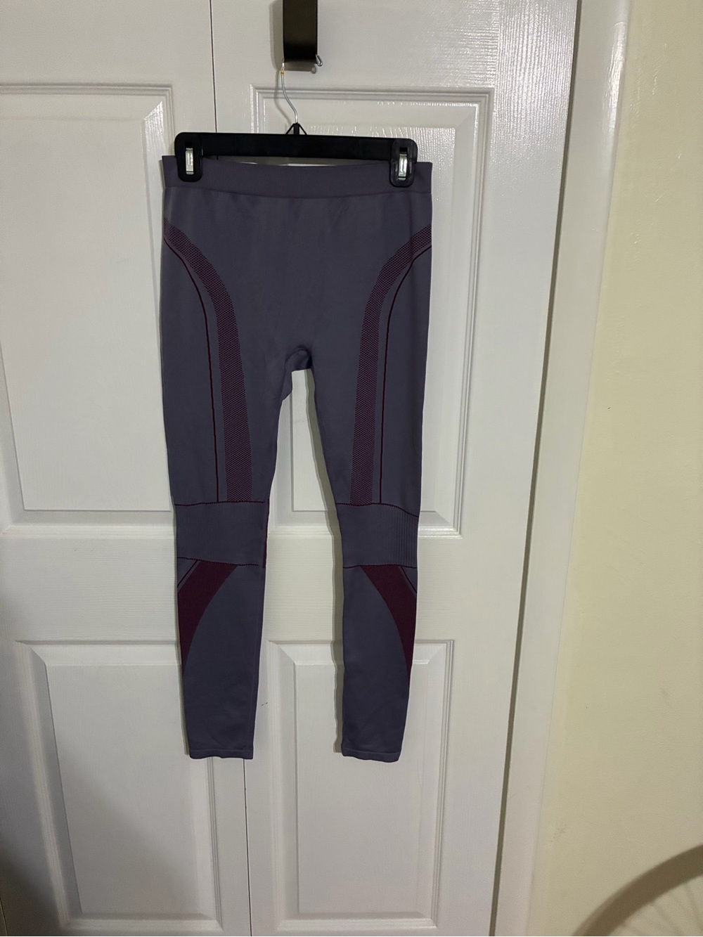 Medium gray workout leggings with knee compression.